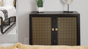 A modern room with a bed, a black cabinet with a geometric pattern, a round mirror, and a potted plant. - 3BR Southwest Modern Haven - Old Town (Scottsdale)