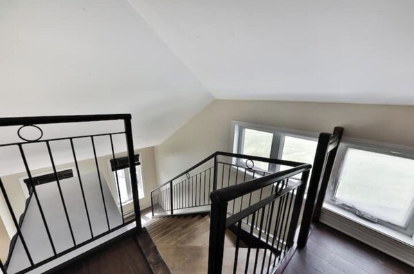 A staircase with black railings leading to an upper floor.
