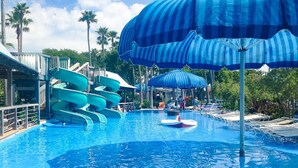 A swimming pool with multiple slides and umbrellas. - Tango Vista With Pool, Elevator, And Beach Views (Miramar Beach)