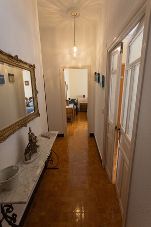 Stylish hallway with sink, mirror, and window.