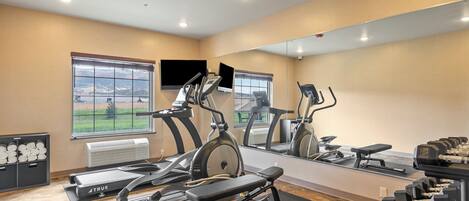 A gym with treadmills, stationary bikes, and weight machines.