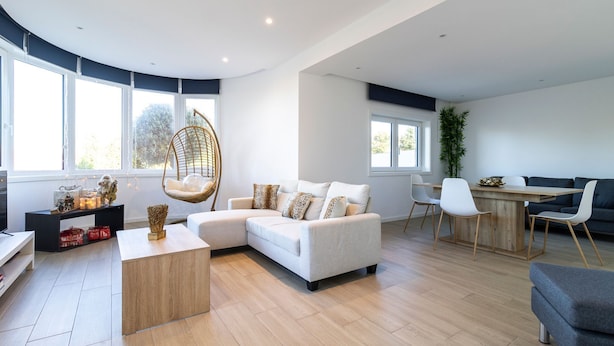 A modern living room with a sofa, a hanging chair, a dining area, and large windows. - GIL LOVE - Luxurious V5 w/ Pool by LovelyStay (Vila Nova de Gaia)