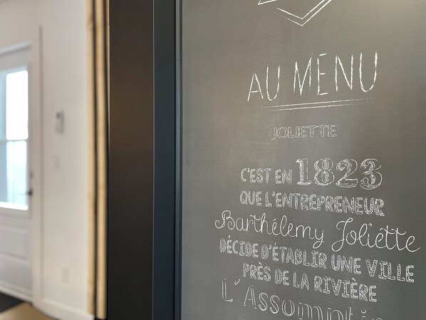 A chalkboard menu with text in French, including the year 1823 and the name Joliette. - In the heart of Joliette "Sol de Musique"! Peace of mind and proximity. (Joliette)