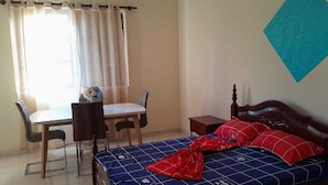 A bedroom with a bed, a desk, and a chair. - The Hidden One (Praia)