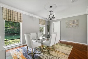 Enjoy meals in this stylish dining area with a glass-top table and comfortable seating.
