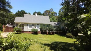 A single-story house with a front porch, a brick foundation, and a well-maintained lawn. - Spacious 4BR/2.5BA•Pet-Friendly•Safe Charlotte Location Near Uptown & SouthPark! (Charlotte)