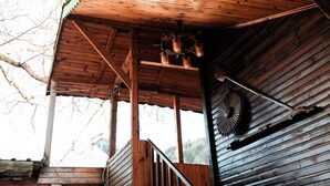 A wooden cabin with a staircase leading to a covered porch. - Abant Barış Pension (Bolu)