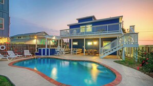 A two-story building with a pool, outdoor seating, and a covered patio area. - Luxe Coastal Stay w/ Private Pool, Walk to Beach Leave of Absence by Avantstay (Port Aransas)