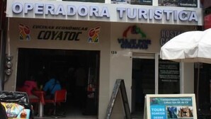 A two-story building with a sign for "TOURS & HOTEL" and "OPERADORATURA TURISTICA" featuring images of wildlife and landmarks. - HOTEL CALLE 8 (Tuxtla Gutierrez)