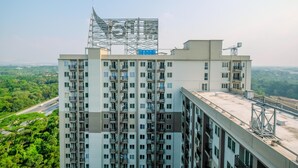 Un immeuble de grande hauteur doté de nombreux balcons et d’une terrasse sur le toit.