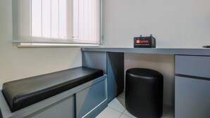 A small, modern kitchenette with a window, a trash bin, and a travelello refrigerator. - Comfy and Homey Studio at Podomoro Golf View Apartment (Gunung Putri)