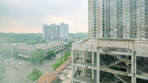 A high-rise building with multiple floors and a central courtyard. - Tidy and Comfortable 2BR Podomoro Golf View Apartment (Gunung Putri)