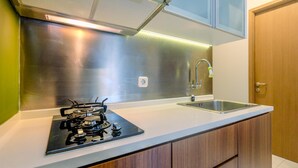 Una cocina moderna con una campana extractora de acero inoxidable, un fregadero y armarios de madera.