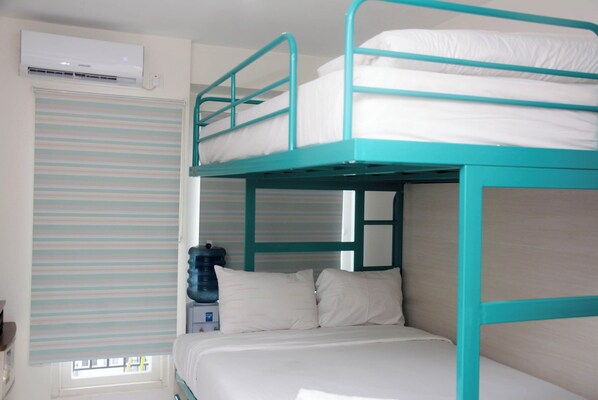 Cozy retreat with a bunk bed, window, and air conditioning unit.