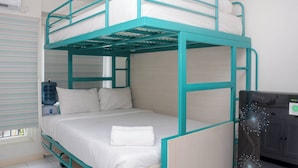 A bunk bed with a water dispenser and a cabinet. - Comfort Studio Apartment for 4 Pax at Podomoro Golf View (Gunung Putri)