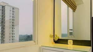 A bathroom with a window, a mirror, and a sink. - Good Place and Comfy 2BR at Podomoro Golf View Apartment (Gunung Putri)