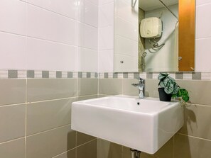 Bathroom features a white sink, mirror, and decorative tile border.