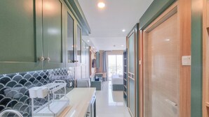 A modern kitchen with a black and white tiled backsplash, white countertops, and a built-in oven.