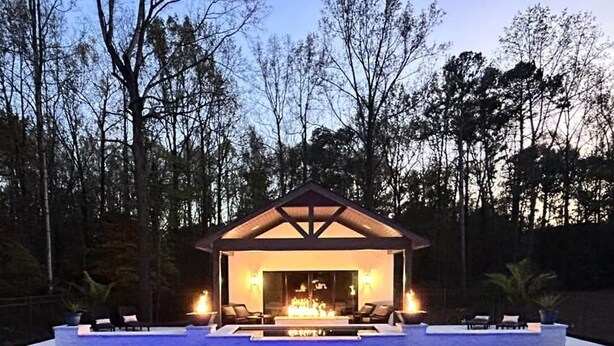 A swimming pool with a fire feature and lounge chairs. - Luxury Guest House w/Resort Style Pool & Spa, pets welcome (Huntersville)