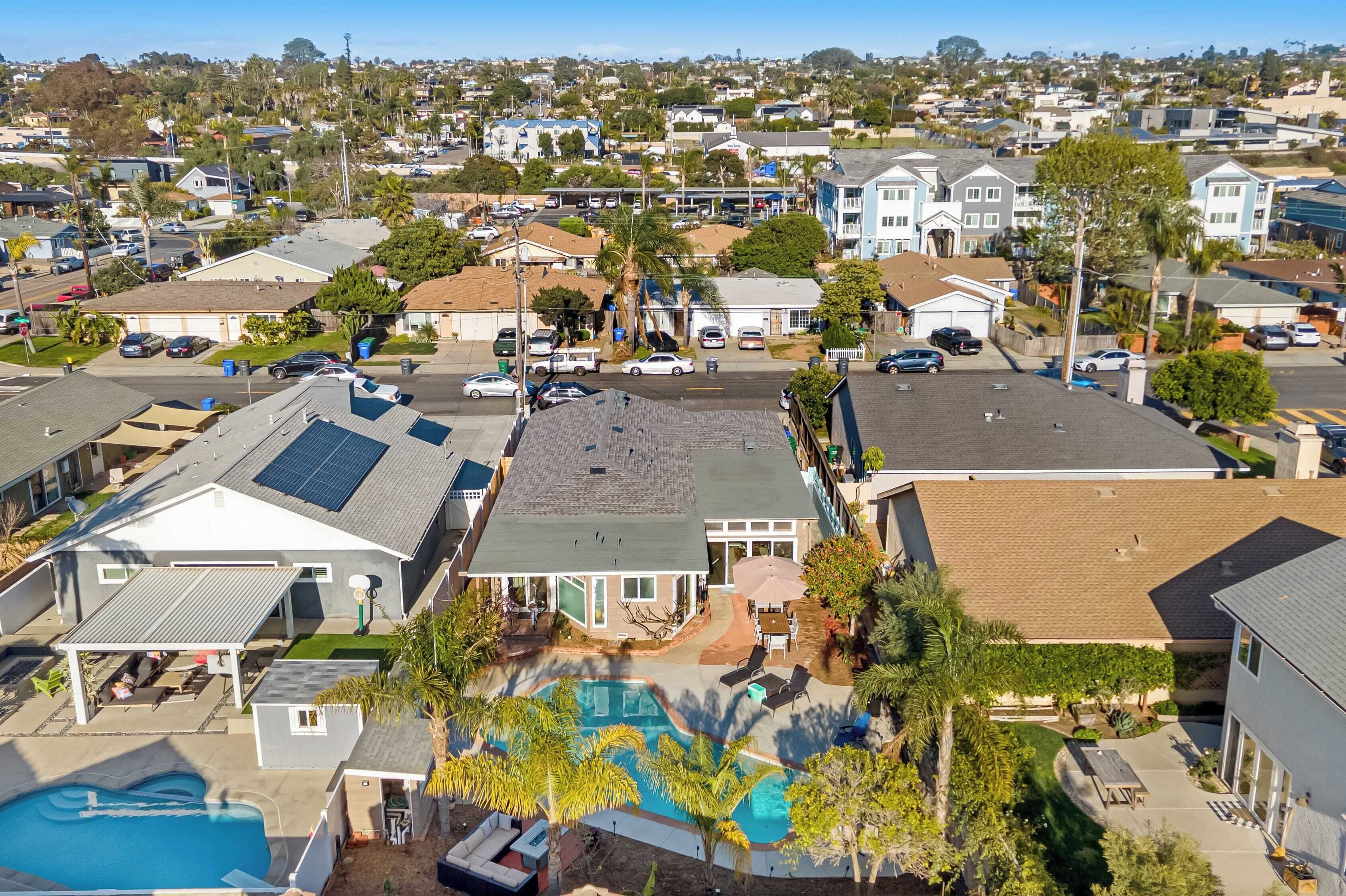 A residential area with houses, a swimming pool, and a covered patio.