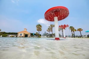 A water feature with a large red structure in the center, surrounded by palm trees and a small building with a tiled roof. - Spacious 5-bedroom house in charming Port Wentworth with WiFi (Port Wentworth)