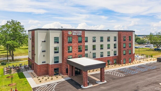 A multi-story hotel with a brick facade and a flat roof.
