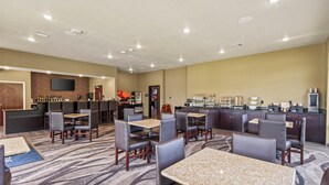 A hotel lobby with a bar area, seating arrangements, and a buffet counter.