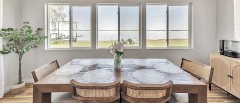 Enjoy meals with family and friends in this spacious dining area, featuring a large table and comfortable seating for six.