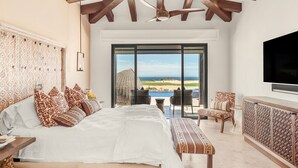 A bedroom with a large bed, a TV, and a view of the beach. - Quivira/Cabo Golf Course Villa W/Awesome OceanView, Infinity Pool on Fairway 18  (Cabo San Lucas)