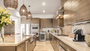 A modern kitchen with a central island, stainless steel appliances, and pendant lighting. - Quivira/Cabo Golf Course Villa W/Awesome OceanView, Infinity Pool on Fairway 18  (Cabo San Lucas)
