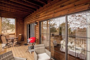 Enjoy a cabin with a spacious deck and a large sliding glass door offering a view of the surrounding landscape.