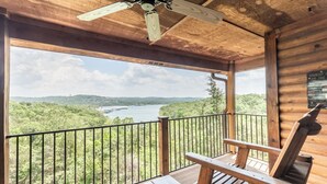 A wooden deck with a view of a lake and forest. - 2BR+Loft Village At Indian Point 1712 near SDC -Free Tickets Daily up to $500 (Branson)