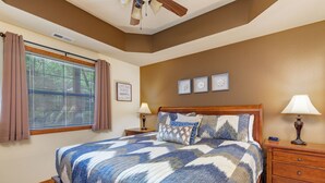 A bedroom with a large bed, two bedside tables, a ceiling fan, and a window with curtains. - 2BR Village At Indian Point 1702 next to SDC- Free Tickets Daily up to $500 (Branson)