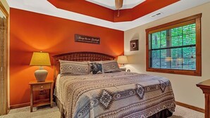 A bedroom with a large bed, two bedside tables with lamps, a ceiling fan, and a window with blinds. - 2BR Village At Indian Point 1801 near SDC - Free Tickets Daily up to $500 (Branson)