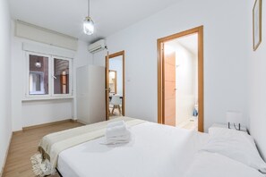 A hotel room with a bed, a window, a door, and a mirror. - C Plaza de Espa a 4B (Madrid)