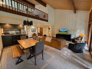 A spacious living area with a dining table, sofas, and a TV. - Condo with Views, Pool, Hot Tub, Workout Center, Golf, On Site Restaurants (Durango)