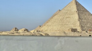A large pyramid structure with a clear sky in the background.