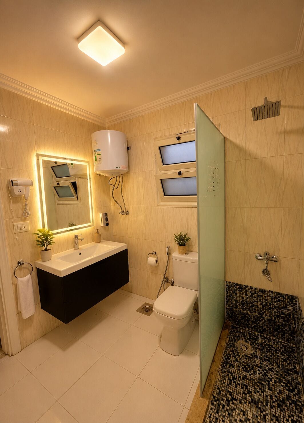 A bathroom with a white sink, a mirror, a toilet, and a shower area.
