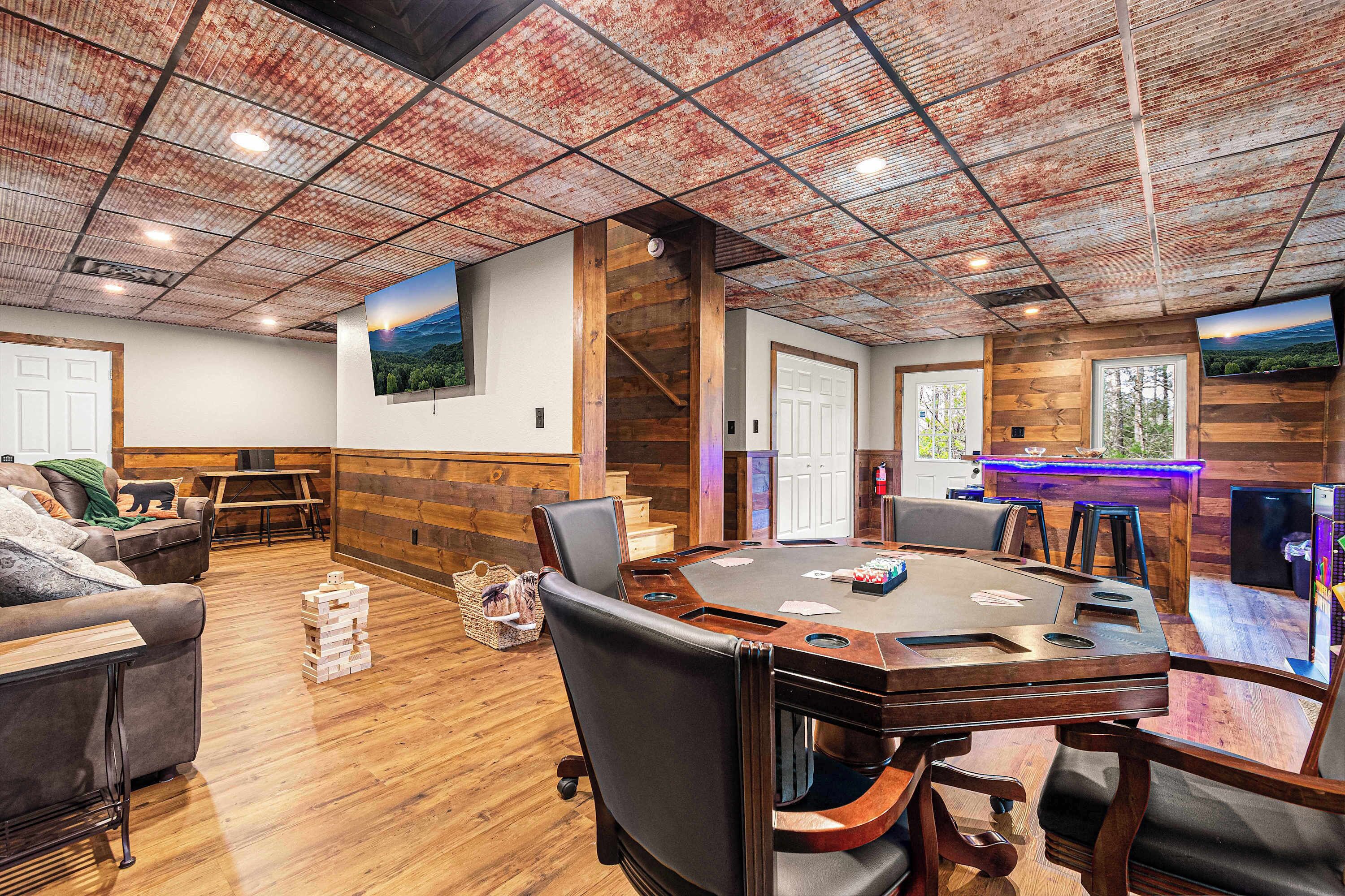 A spacious room with a large wooden table, comfortable seating, and a rustic ceiling.