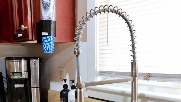 A kitchen with a stainless steel sink, a coffee maker, and a bottle of hand soap. - Cozy, gallery-inspired stay, 5min to Fort Liberty (Fayetteville)