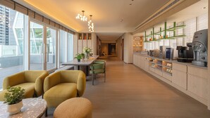 A modern kitchen with a long counter, built-in appliances, and a view of the city. - 采寓halo house (Taichung)