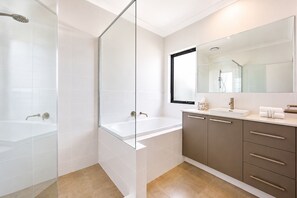A modern bathroom with a glass-enclosed shower, a standalone bathtub, and a vanity with a mirror. - 5 O Clock Somewhere (West Busselton)