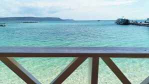 Vista de un mar tranquilo con barcos y un muelle.