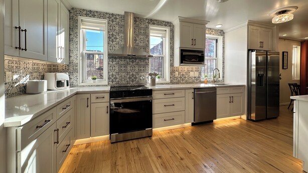 A modern kitchen with white cabinetry, a stainless steel oven, and a built-in microwave. - Luxury Private Boutique Hotel with CityView, Hot Tub, Free Parking (Pittsburgh)