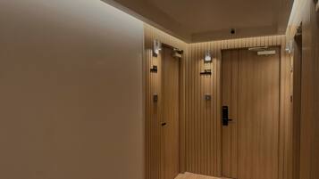 A modern elevator with wooden paneling and a digital display.