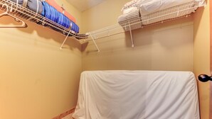 A small, enclosed room with a bunk bed, a drying rack, and a covered mattress. - 3-bedroom Cabin 13 in Bridges Bay, with on site eating and in/outdoor pool. (Arnolds Park)