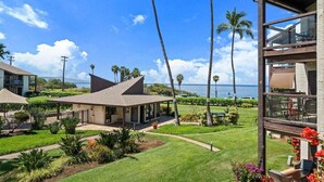A beachfront property with a covered patio, a pool, and a view of the ocean.