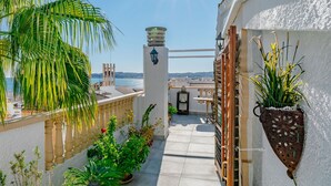 A balcony with potted plants, a view of the sea, and a clear sky. - Xabia Port Plus by Interhome (Jávea)