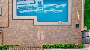 A swimming pool with a mural of boats and a stone wall. - Xabia Port Plus by Interhome (Jávea)