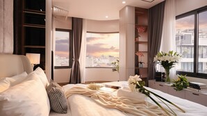 A modern bedroom with a large bed, a city view, and a bookshelf. - Crescendo Unique Studio (Hanoi)